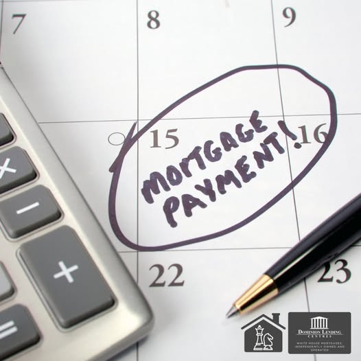 A worried homeowner reviewing bills at a kitchen table in Salmon Arm, representing the financial impact of a missed mortgage payment.